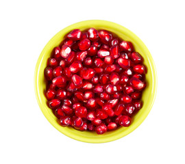 pomegranate seeds in a bowl isolated on white