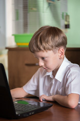 boy with laptop at table