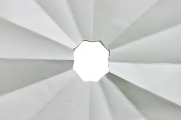Hole ripped in white paper