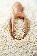 sesame seeds in a wooden scoop