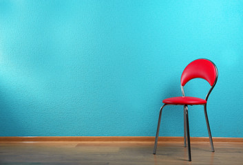 Red chair on blue wall background
