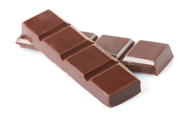 Black chocolate pieces isolated on white background