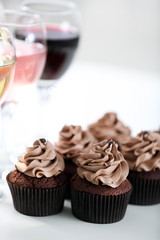Tasting of wine and chocolate cupcakes, close up