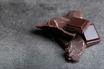 Dark chocolate pieces on  dark gray background