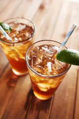 iced tea with lime wedge and retro paper straws close up