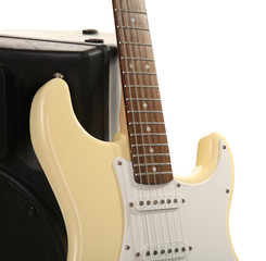 Electric guitar with musical equipment on light background
