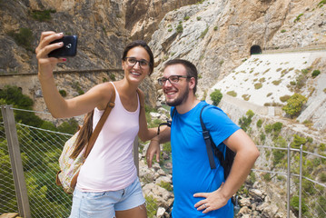 Young couple taking a selfie in mountainous place - Powered by Adobe