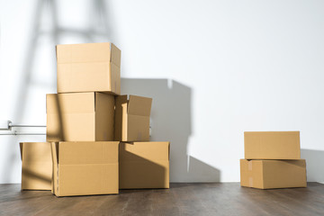 Pile of cardboard boxes on white background with  Ladder shadow