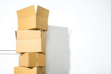 Pile of cardboard boxes on white background with box shadow