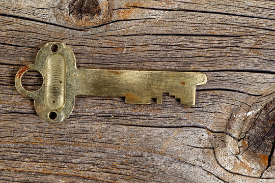 Vintage key on rustic wood