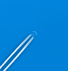 Closeup on airplane contrail against clear blue sky