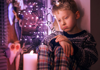 Sad Little boy waiting for Christmas presents