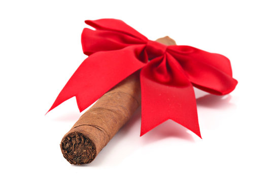 Cigar with christmas ribbon isolated on white, shallow focus