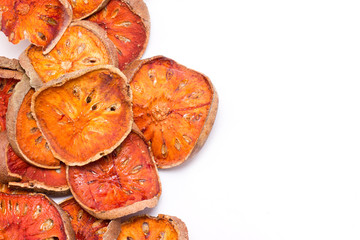 Slices of dried bael fruit isolated on white.