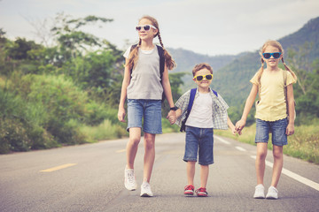 Happy children walking on the road.