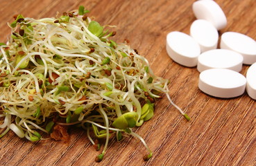 Alfalfa and radish sprouts with tablets supplements, healthy nutrition