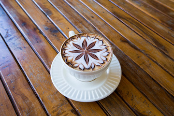 Latte Coffee art on the wooden desk.