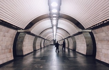two men shake each other hands in the depths of underground
