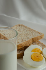 Easy Breakfast with Whole Grain Bread, Boiled Egg and Milk.