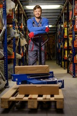 Loader using hand pallet truck in a warehouse