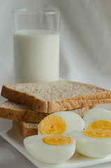 Easy Breakfast with Whole Grain Bread, Boiled Egg and Milk.