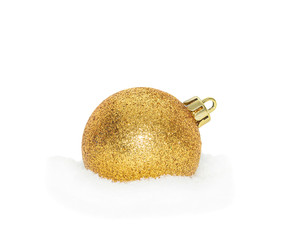 Gold Christmas New Year bauble, ball lying on the white snow, snowy, isolated on a white background