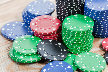 Poker chips over wooden background