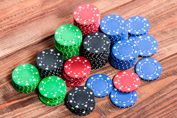 Poker chips over wooden background
