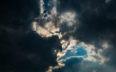 Dramatic sunset sky with dark clouds.