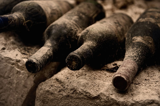 Old wine bottles on a stone step, a cave