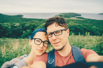 Young couple doing selfie on nature