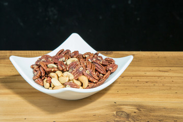 pecan nuts in white bowl
