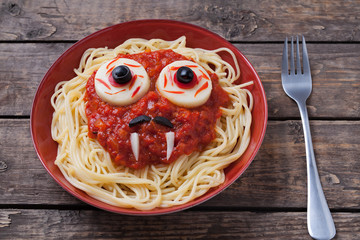 Halloween spaghetti face with big eyeballs fangs and moustaches