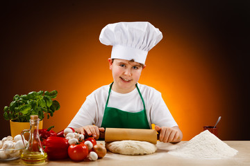 Boy making pizza dough 