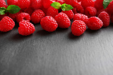 Fresh red raspberries on wooden background