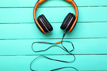 Headphones on wooden background