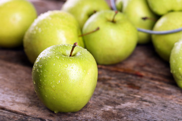 Ripe green apples on wooden table close up