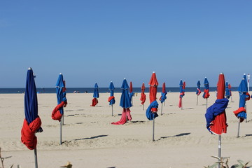 Sun umbrellas on the beach of Normandy