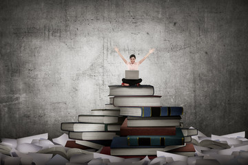 Asian business person working with laptop sit on top of book
