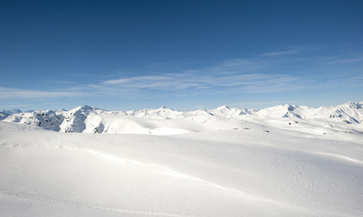 Naklejka na ściany i meble Panoramic view over a snowy mountain range