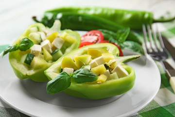 Fresh green salad in pepper on table close up