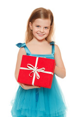 Little cute girl in blue dress holding a gift box, isolated on the white background