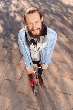 Positive man riding a scooter 
