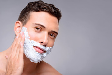 Pleasant guy shaving 