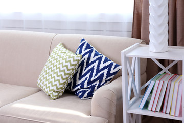Comfortable sofa  with different pillows in the room, close up