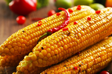 Tasty grilled corn with vegetables, close up