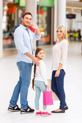 Friendly family walking around shopping mall 