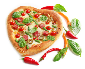 Tasty heart shaped pizza decorated with hot peppers and basil isolated on white background