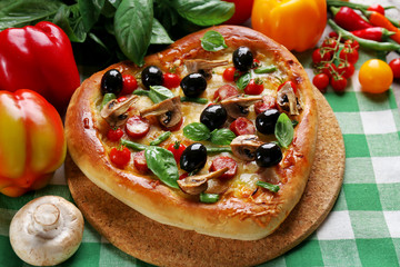 Heart shaped pizza green checked cotton serviette decorated with vegetables