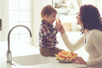 Mother and child eating in the kitchen